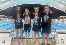 West Coast swims to win